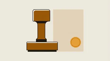 A rubber stamp beside a blank sheet with a plain circular seal